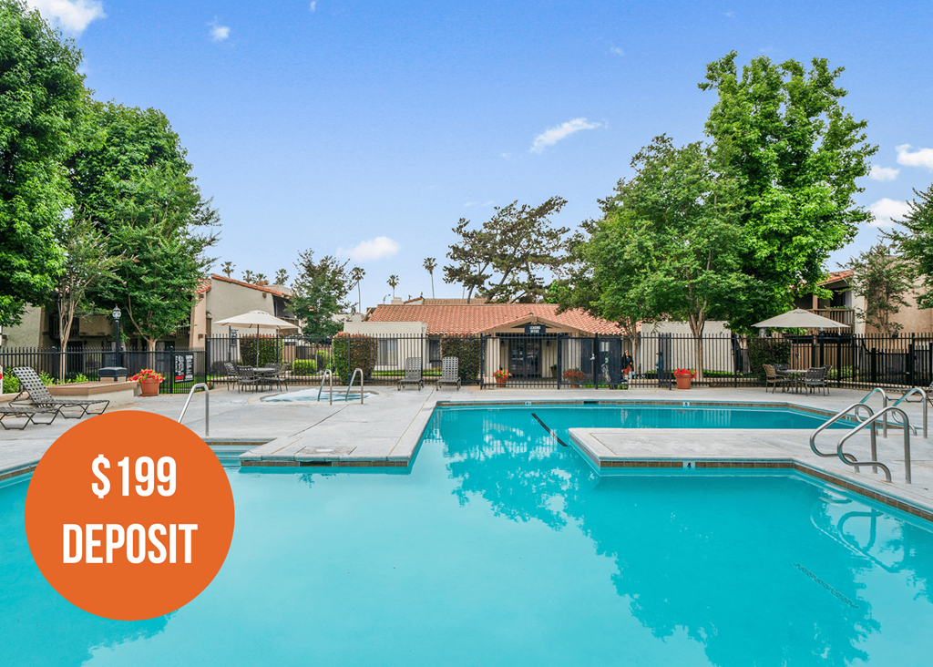 a swimming pool with trees and a building in the background